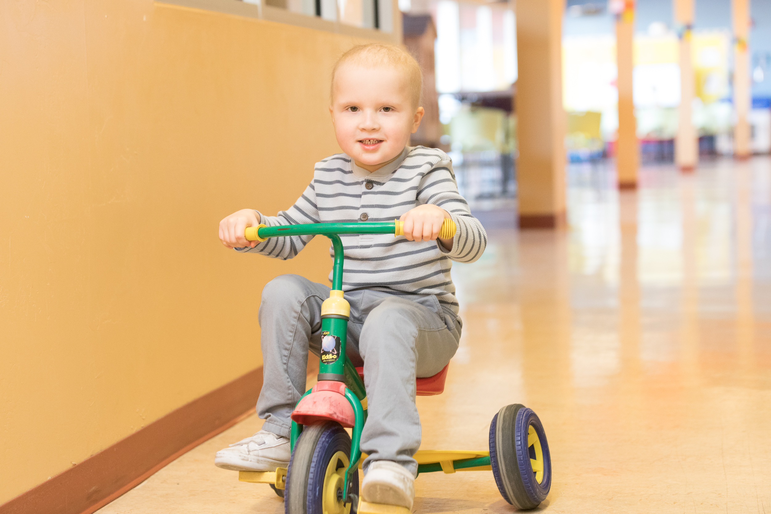 Young Mason on his tricycle riding through the halls of rmhc