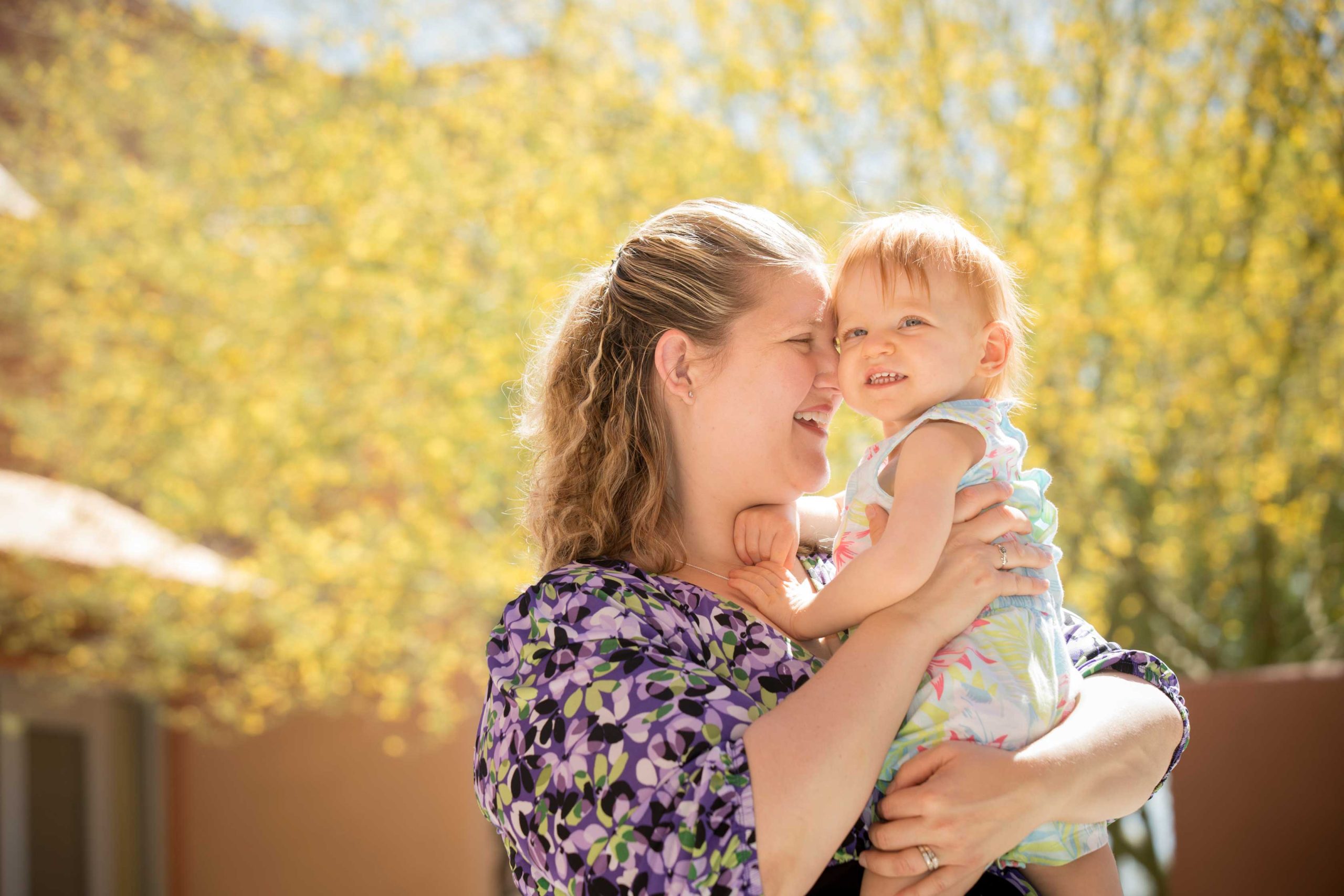 Mother Stacye holds and presses forehead with daughter Olivia B&W