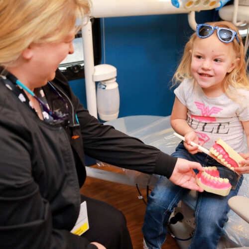 little girl reading at RMHC of Southern Arizona